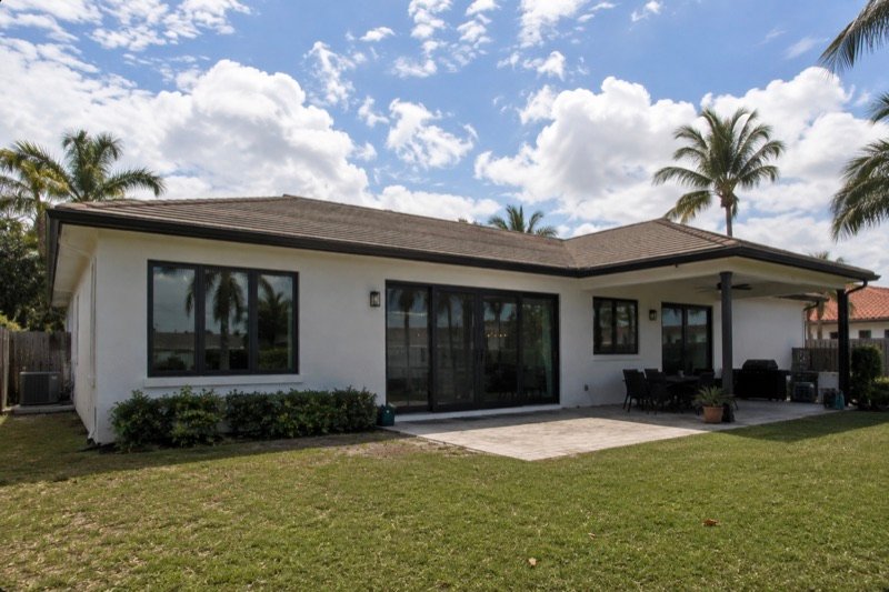 Miami home with black-framed impact windows and sliding glass doors